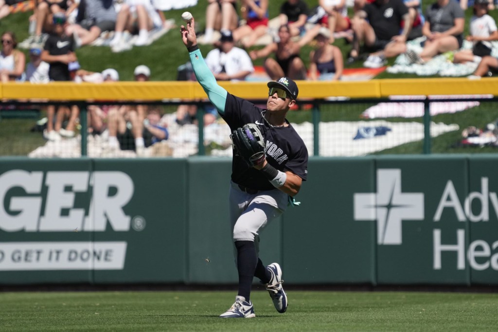 Mar 23, 2026; Mesa, Arizona, USA; New York Yankees right fielder Aaron Judge (99) fields the ball against the Chicago Cubs in the third inning at Sloan Park.