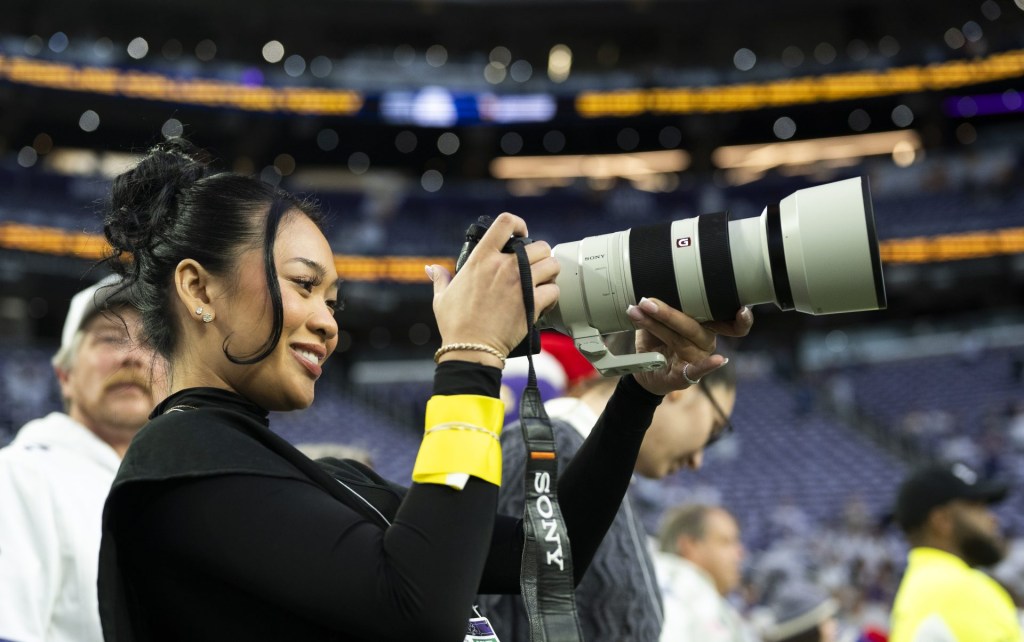 MINNEAPOLIS, MINNESOTA - DECEMBER 25: Olympic gymnast Sunisa Lee is photographs warmups prior to the game between the Minnesota Vikings and the Detroit Lions at U.S. Bank Stadium on December 25, 2025 in Minneapolis, Minnesota