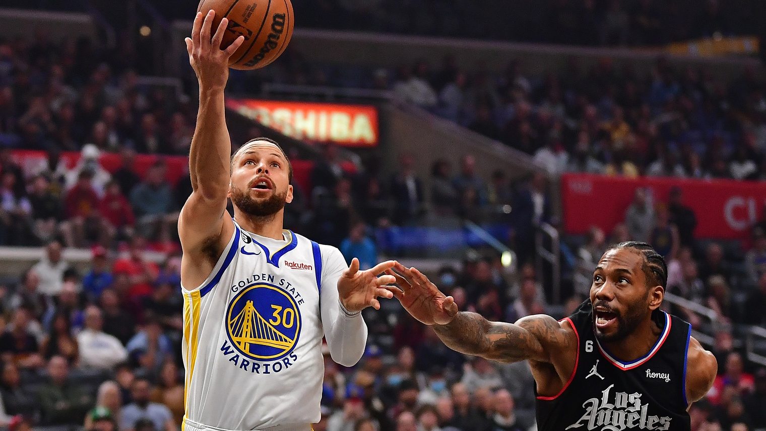 Mar 15, 2023; Los Angeles, California, USA; Golden State Warriors guard Stephen Curry (30) moves to the basket against Los Angeles Clippers forward Kawhi Leonard (2) during the first half at Crypto.com Arena. Mandatory Credit: Gary A. Vasquez-USA TODAY Sports