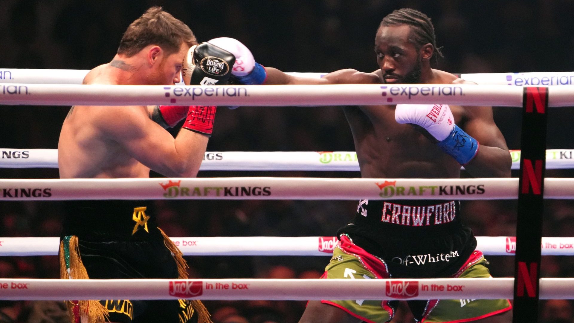 Sep 13, 2025; Las Vegas, Nevada, USA; Canelo Alvarez (black/gold trunks) and Terence Crawford (black/red trunks) box during their super middleweight title bout at Allegiant Stadium. Mandatory Credit: Joe Camporeale-Imagn Images