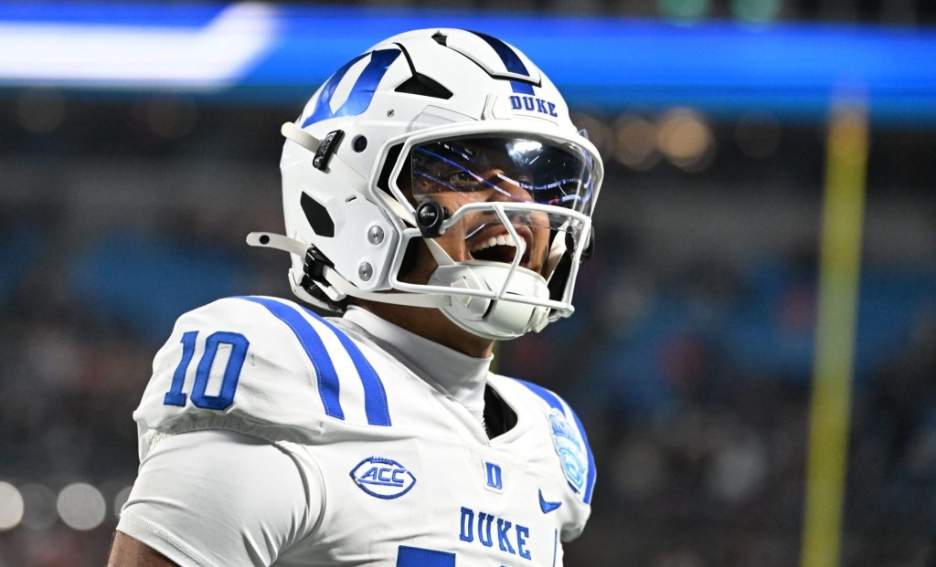 Dec 6, 2025; Charlotte, NC, USA; Duke Blue Devils quarterback Darian Mensah (10) celebrates after the Blue Devils score a touchdown in overtime during the ACC Championship game at Bank of America Stadium.