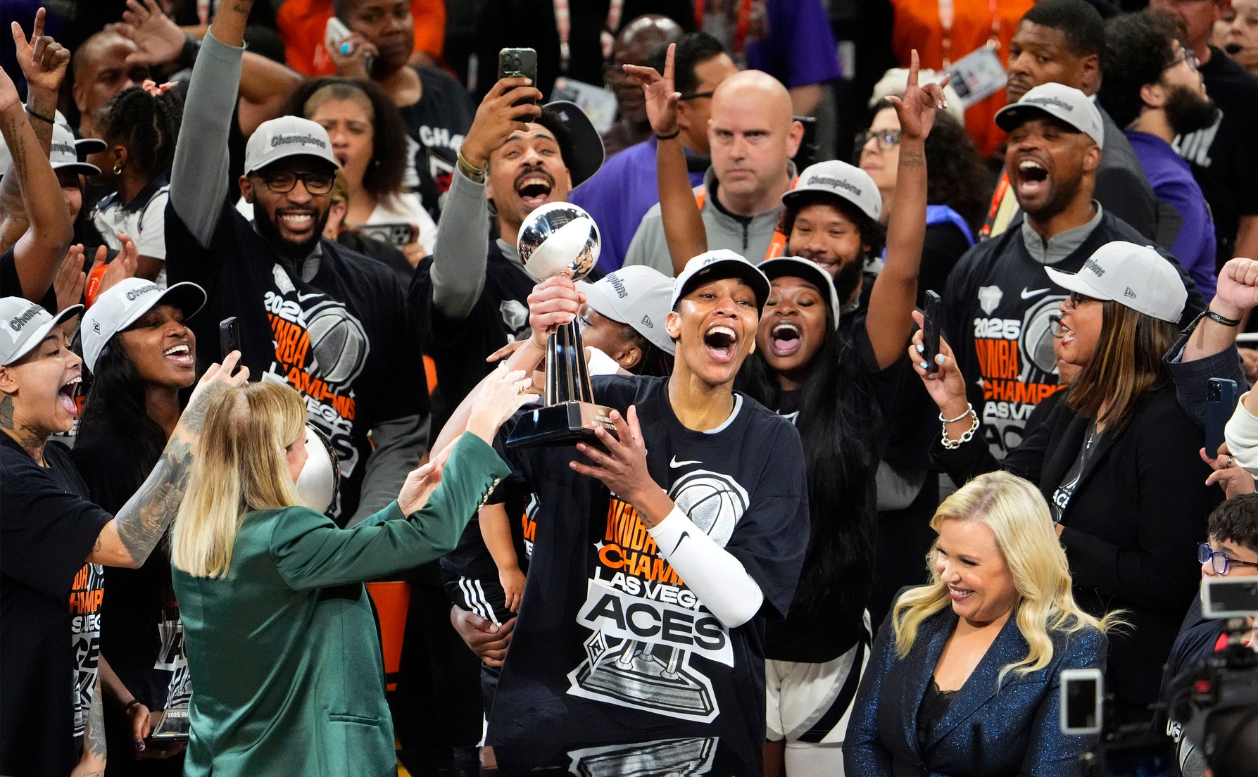 Las Vegas Aces center A'ja Wilson (22) celebrates as she receives the MVP trophy after defeating the Phoenix Mercury 97-86 to win the WNBA Championship in a four-game sweep in Game Four of the WNBA Finals at Mortgage Matchup Center on Oct. 10, 2025, in Phoenix.