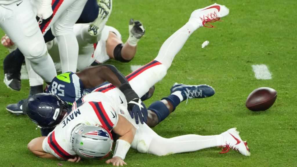 Feb 8, 2026; Santa Clara, CA, USA; New England Patriots quarterback Drake Maye (10) fumbles as he is sacked by Seattle Seahawks linebacker Derick Hall (58) in the second half in Super Bowl LX at Levi's Stadium