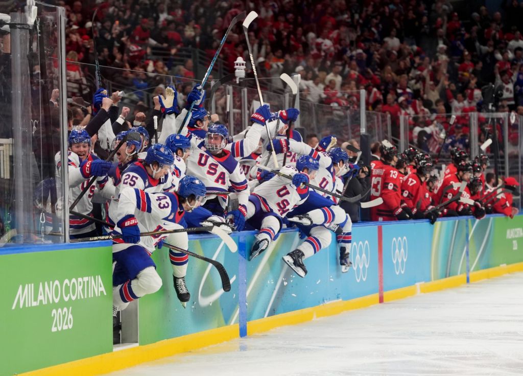 Feb 22, 2026; Milan, Italy; United States bench react after the game-winning goal is scored by Jack Hughes (not pictured) of the United States against Canada in the men's ice hockey gold medal game during the Milano Cortina 2026 Olympic Winter Games at Milano Santagiulia Ice Hockey Arena.