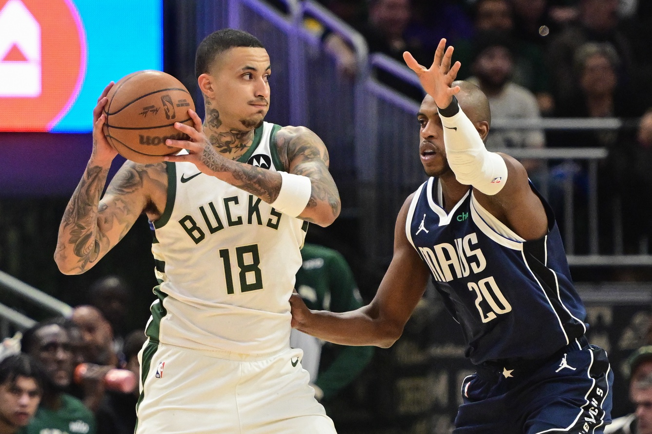 Mar 31, 2026; Milwaukee, Wisconsin, USA; Milwaukee Bucks forward Kyle Kuzma (18) looks for a shot against Dallas Mavericks forward Khris Middleton (20) in the first quarter at Fiserv Forum.