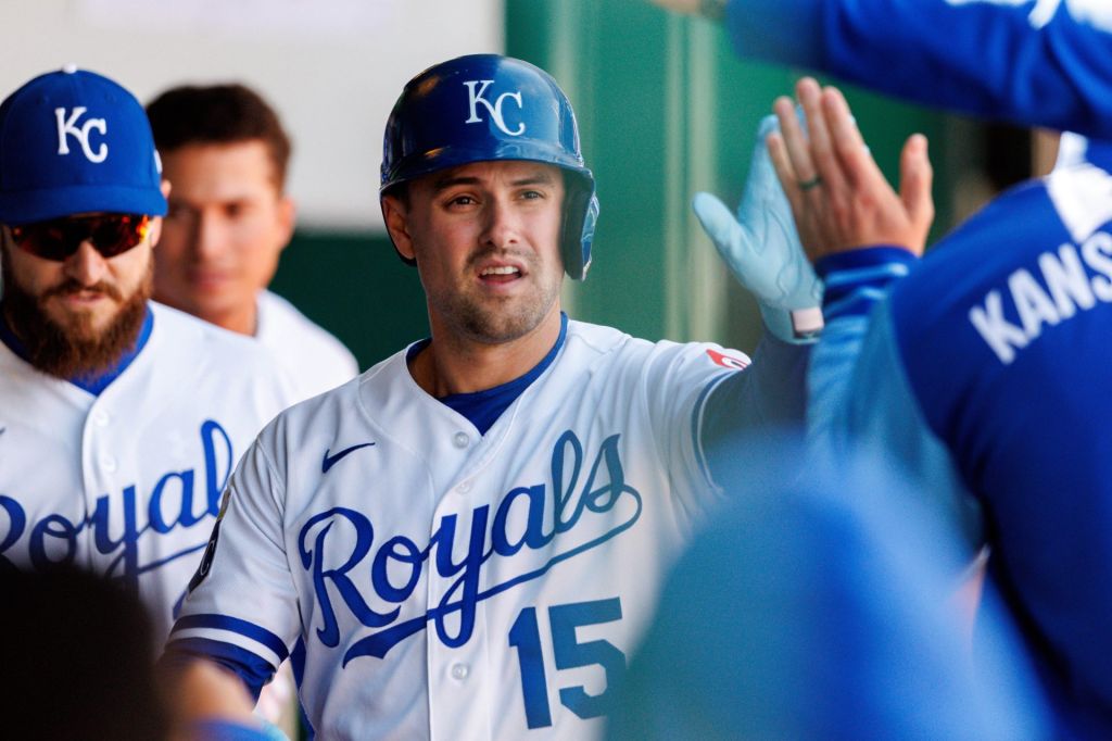 Apr 4, 2026; Kansas City, Missouri, USA; Kansas City Royals center fielder Lane Thomas (15) celebrates in the dugout after scoring during the seventh inning against the Milwaukee Brewers at Kauffman Stadium.