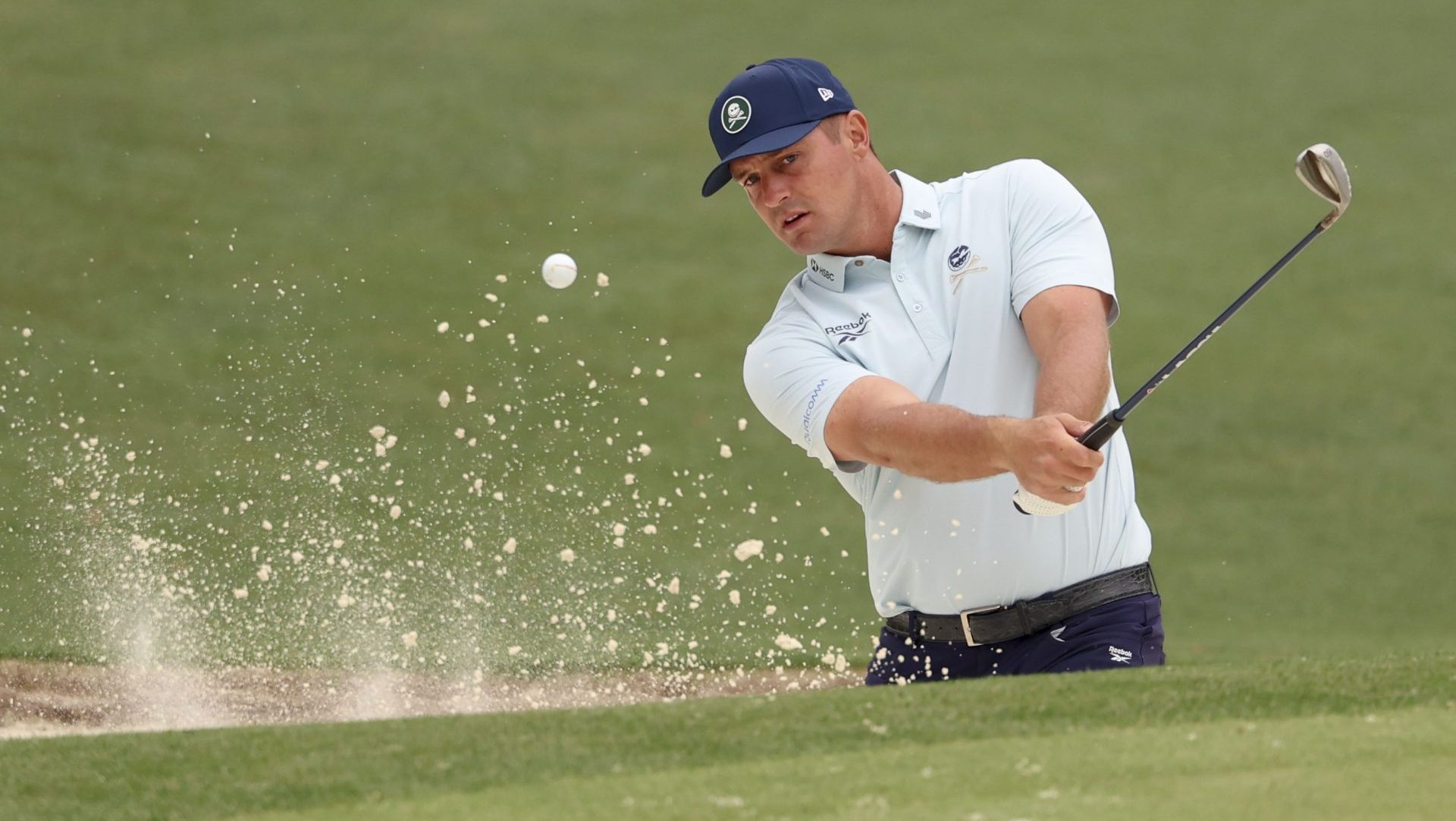 Apr 6, 2026; Augusta, Georgia, USA; Bryson DeChambeau hits out of the bunker and onto the 16th green during a practice round for the Masters Tournament at Augusta National Golf Club