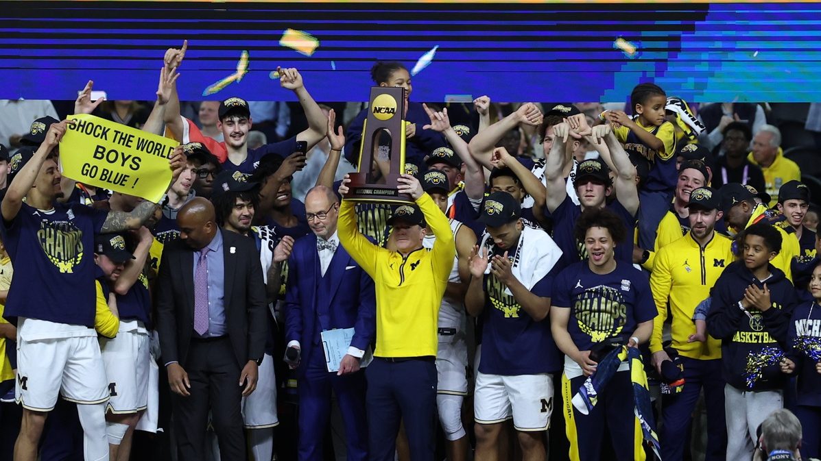Apr 6, 2026; Indianapolis, IN, USA; Michigan Wolverines head coach Dusty May celebrates with the trophy after defeating the UConn Huskies in the national championship of the Final Four of the men's 2026 NCAA Tournament at Lucas Oil Stadium.