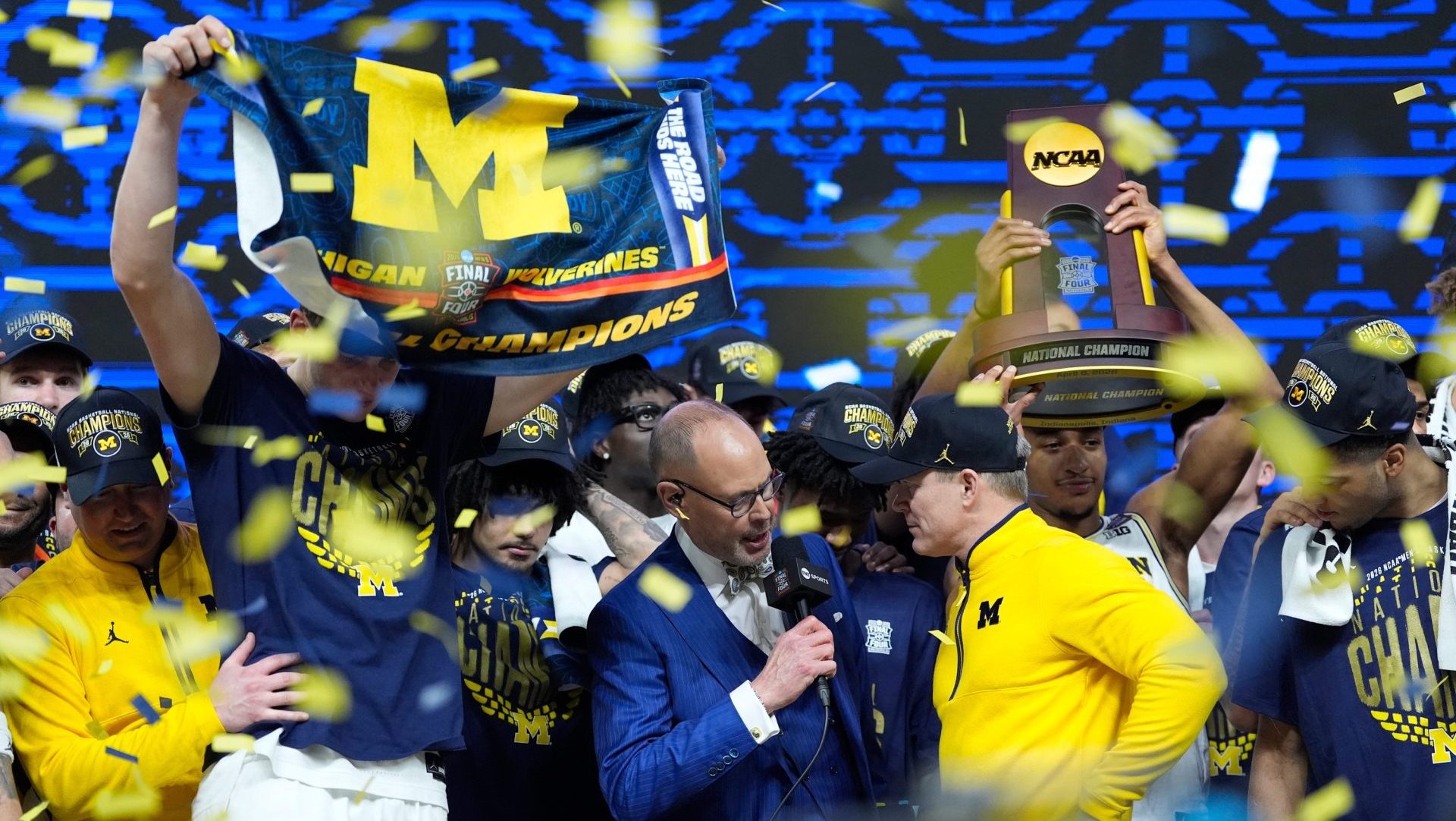 Michigan head coach Dusty May does an interview on stage as the team celebrates beating Connecticut to win the NCAA national championship at Lucas Oil Stadium in Indianapolis on Monday, April 6, 2026.