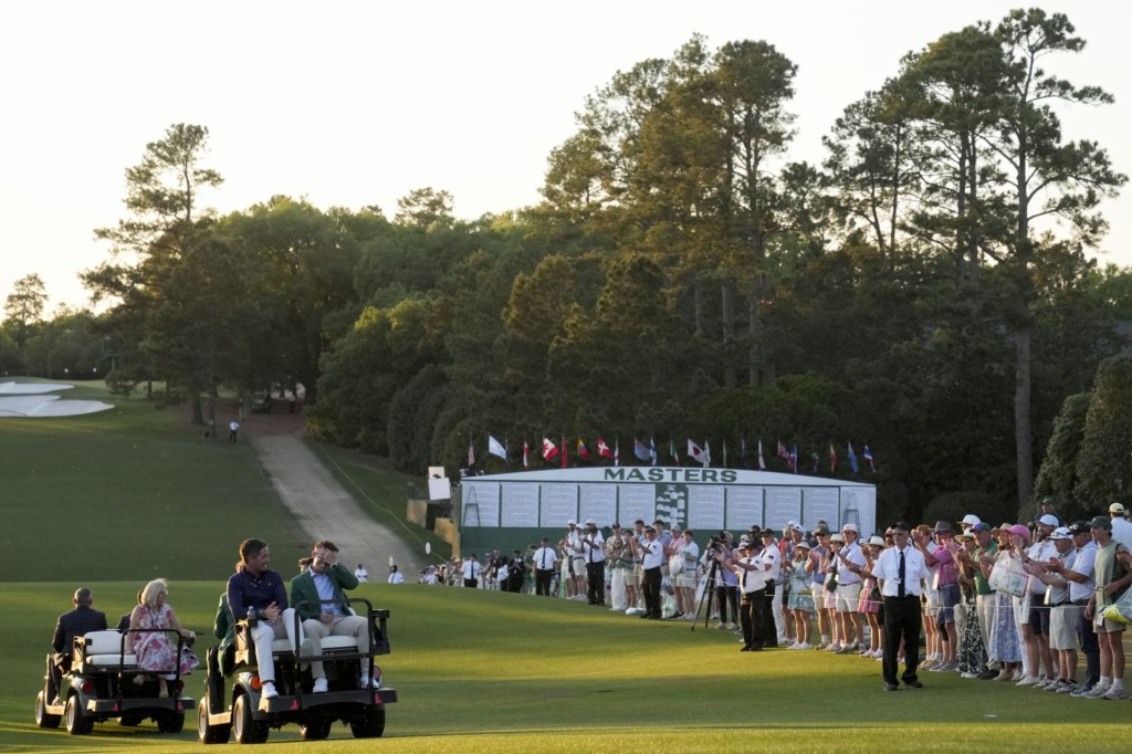 Apr 12, 2026; Augusta, Georgia, USA; Rory McIlroy takes a golf cart to the press building following the green jacket ceremony during the final round of the Masters Tournament at Augusta National Golf Club.