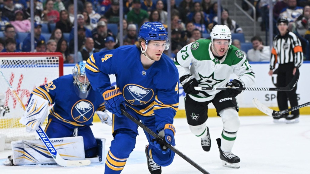 Apr 15, 2026; Buffalo, New York, USA; Buffalo Sabres defenseman Bowen Byram (4) clears the puck from the goal with Dallas Stars left wing Adam Erne (73) in pursuit in the third period at KeyBank Center.