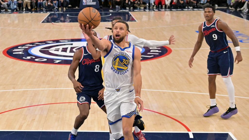Apr 15, 2026; Inglewood, California, USA; Golden State Warriors guard Stephen Curry (30) drives past Los Angeles Clippers guard Kris Dunn (8) and guard Darius Garland (10) in the second half during the play-in rounds of the 2026 NBA Playoffs at Intuit Dome.