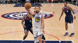 Apr 15, 2026; Inglewood, California, USA; Golden State Warriors guard Stephen Curry (30) drives past Los Angeles Clippers guard Kris Dunn (8) and guard Darius Garland (10) in the second half during the play-in rounds of the 2026 NBA Playoffs at Intuit Dome.