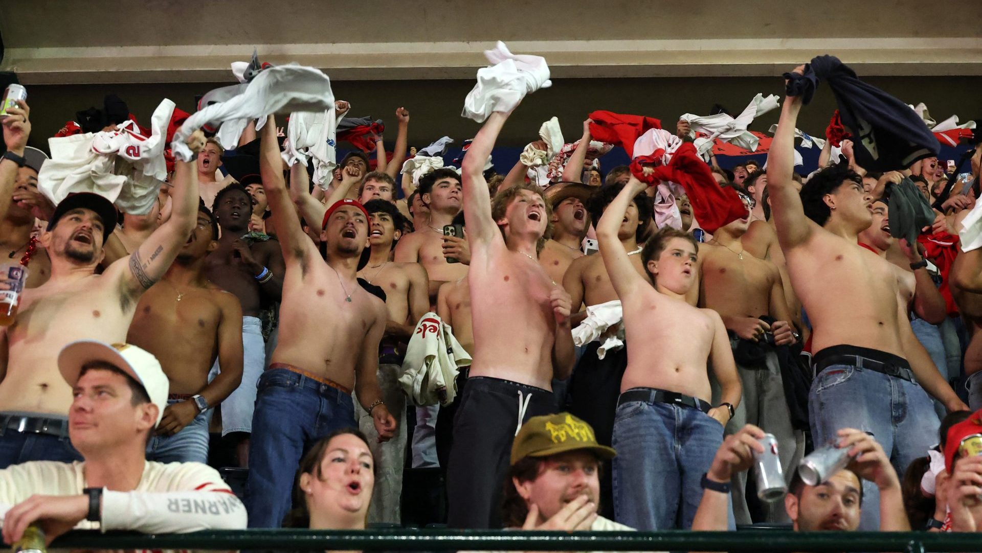 May 23, 2026; Anaheim, California, USA; Fans participate in a tarp off during a MLB game between the Los Angeles Angels and the Texas Rangers at Angel Stadium