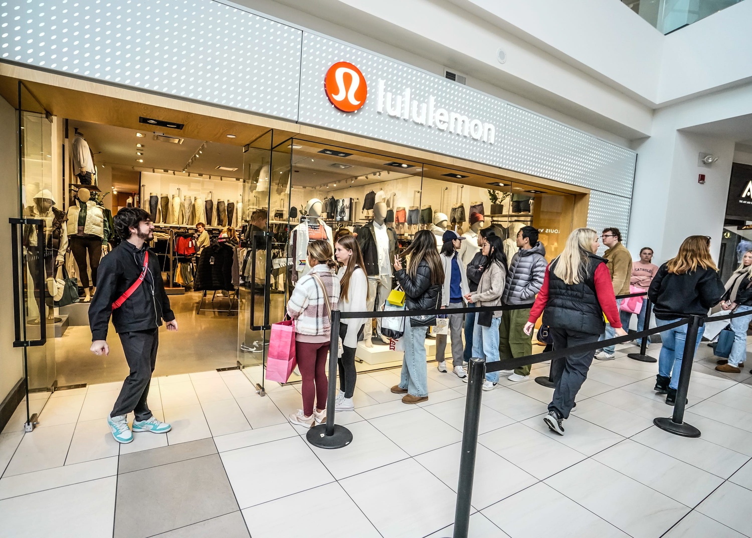 Holliday shoppers stand in line for Black Friday deals at Lululemon in the Fashion Mall at Keystone on Friday, Nov. 29, 2024, in Indianapolis.