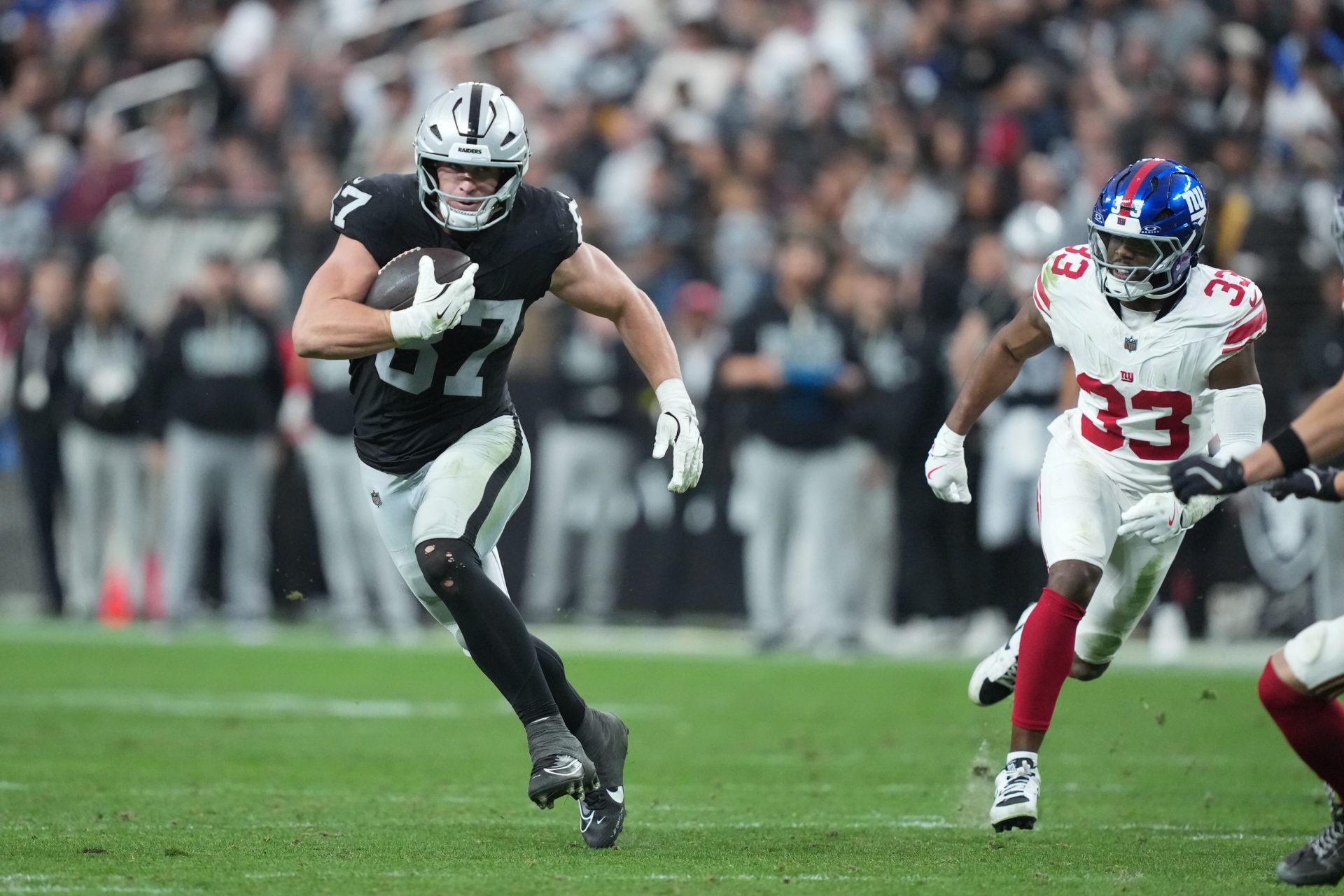 Dec 28, 2025; Paradise, Nevada, USA; Las Vegas Raiders tight end Michael Mayer (87) runs with the ball in the third quarter against the New York Giants at Allegiant Stadium.