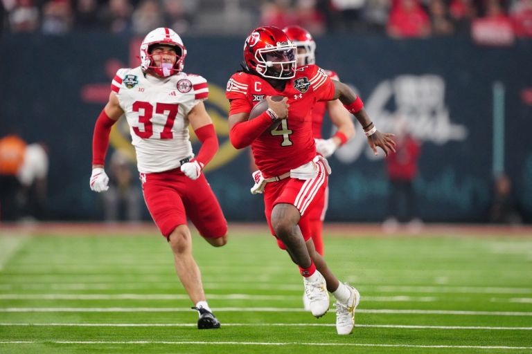 Dec 31, 2025; Las Vegas, NV, USA; Utah Utes quarterback Devon Dampier (4) carries the ball against Nebraska Cornhuskers defensive back Donovan Jones (37) in the second half during the SRS Distribution Las Vegas Bowl at Allegiant Stadium.