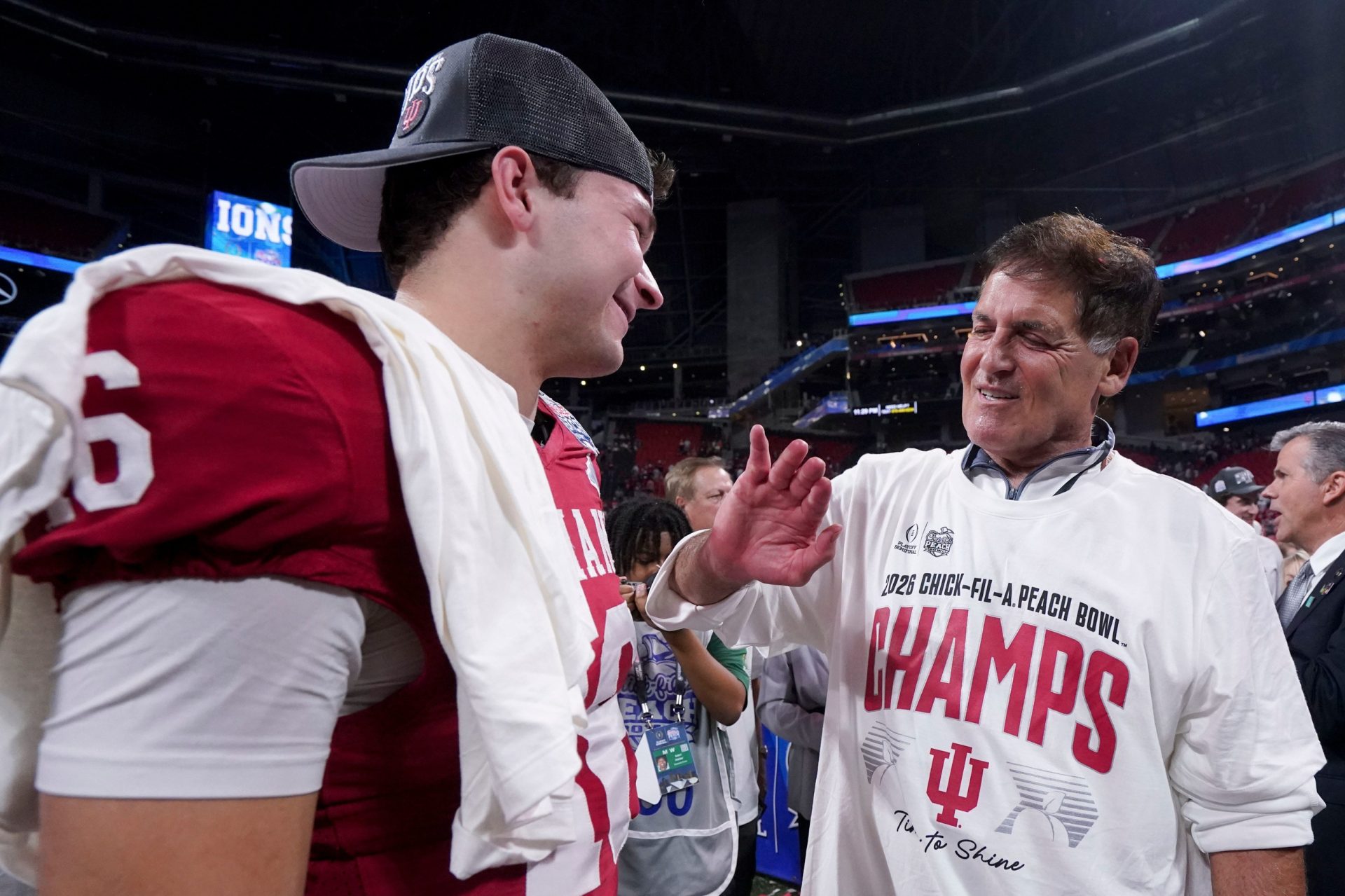Mark Cuban talks with Indiana Hoosiers quarterback Alberto Mendoza (16) on Friday, Jan. 9, 2026, after the Indiana Hoosiers defeated the Oregon Ducks in the Peach Bowl and semifinal game of the College Football Playoff at Mercedes-Benz Stadium in Atlanta.