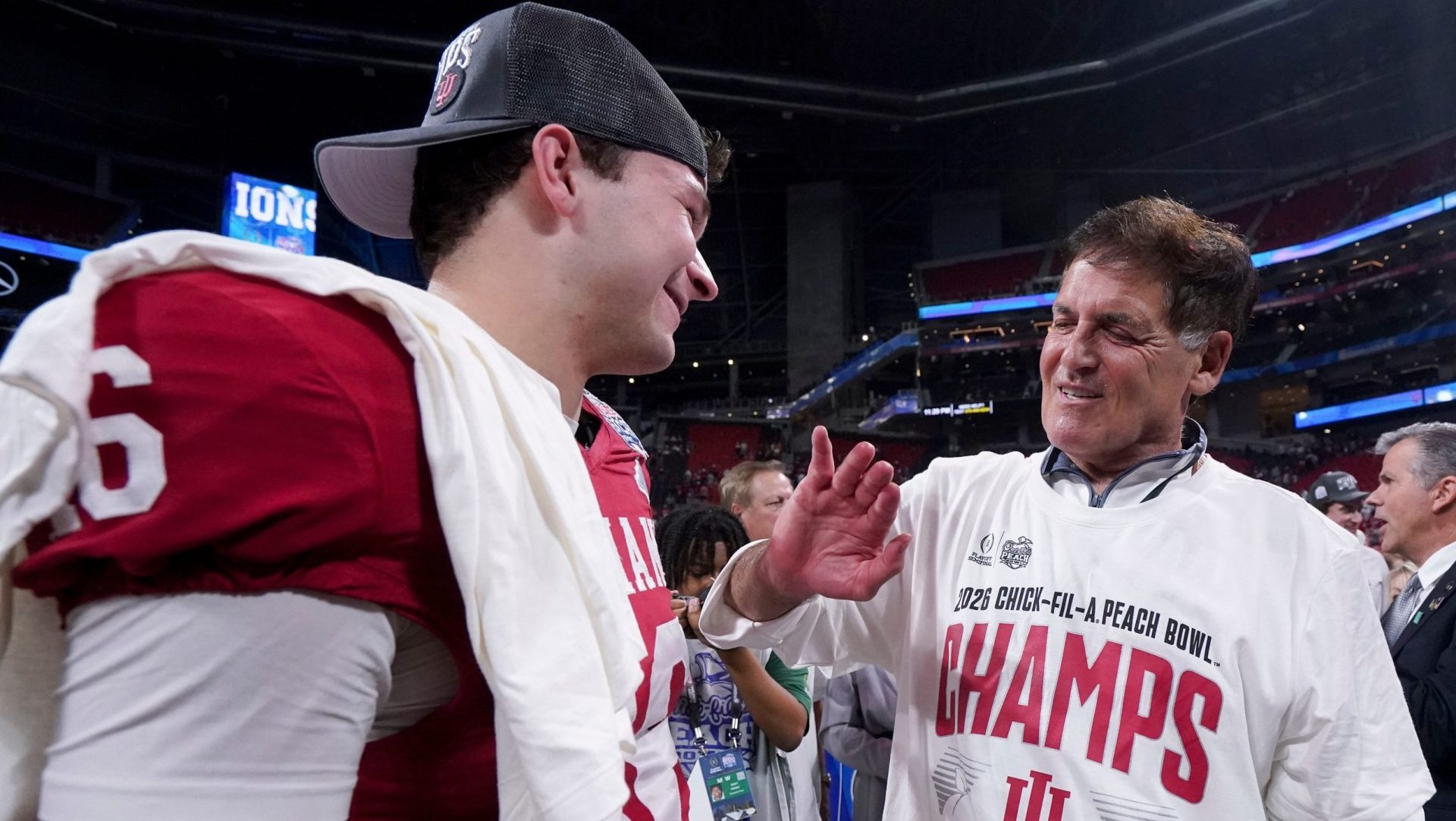 Mark Cuban talks with Indiana Hoosiers quarterback Alberto Mendoza (16) on Friday, Jan. 9, 2026, after the Indiana Hoosiers defeated the Oregon Ducks in the Peach Bowl and semifinal game of the College Football Playoff at Mercedes-Benz Stadium in Atlanta.