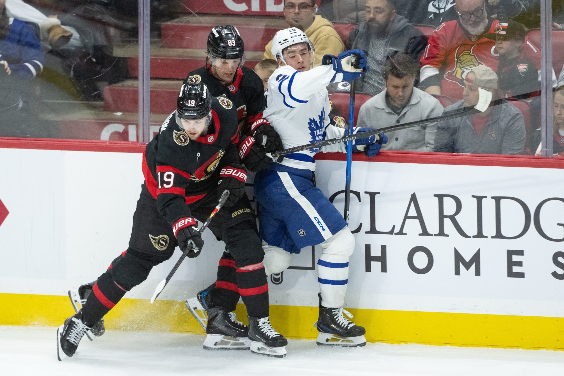 Apr 15, 2026; Ottawa, Ontario, CAN; Ottawa Senators right wing Drake Batherson (19) and center Stephen Halliday (83) battle with Toronto Maple Leafs center Jacob Quillan (26) in the third period at the Canadian Tire Centre.