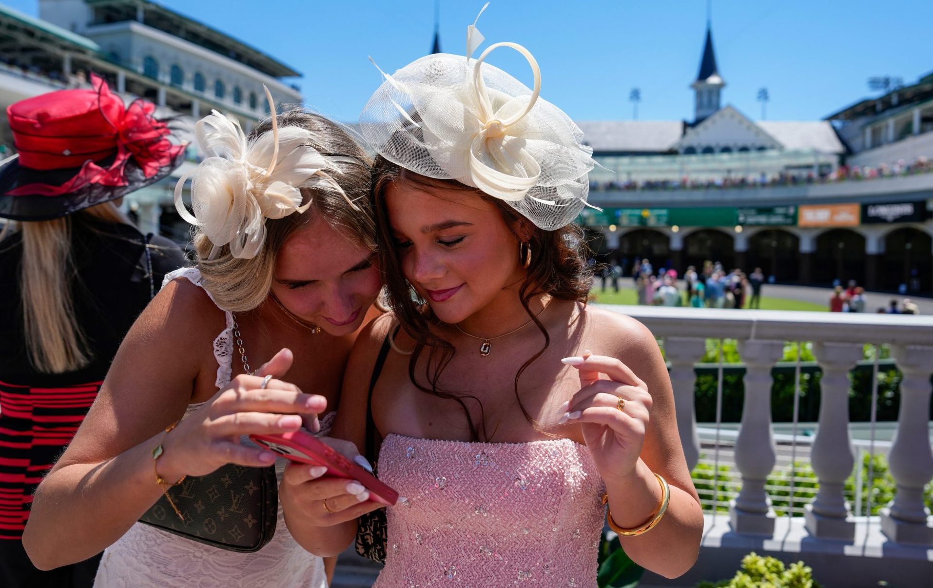 Kaitlin Oaks (left) from Tampa looks at photos with Layla Abutha from Tampa while attending Thurby at Churchill Downs during the week of Kentucky Derby on Thursday, April 30, 2026.