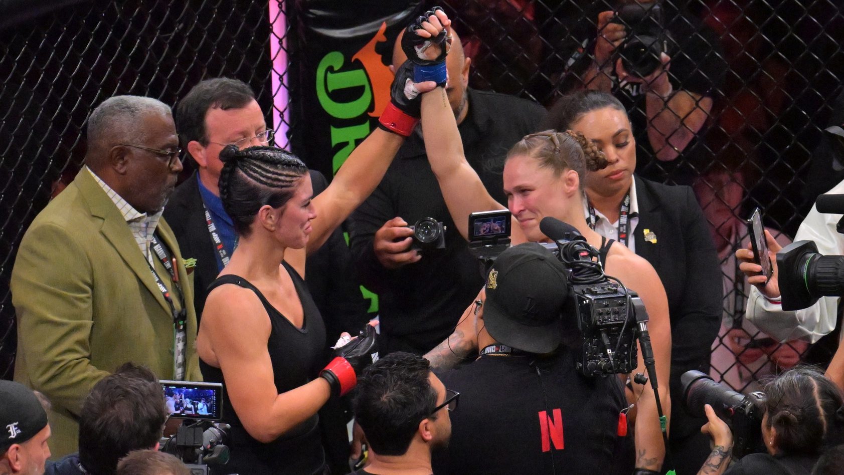 May 16, 2026; Los Angeles, California, USA; Ronda Rousey (blue gloves) celebrates defeating Gina Carano (red gloves) after a women's featherweight bout at Intuit Dome. Mandatory Credit: Jayne Kamin-Oncea-Imagn Images