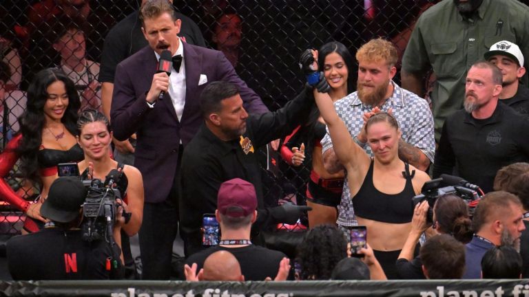 May 16, 2026; Los Angeles, California, USA; Ronda Rousey (blue gloves) celebrates defeating Gina Carano (red gloves) after a women's featherweight bout at Intuit Dome. Mandatory Credit: Jayne Kamin-Oncea-Imagn Images