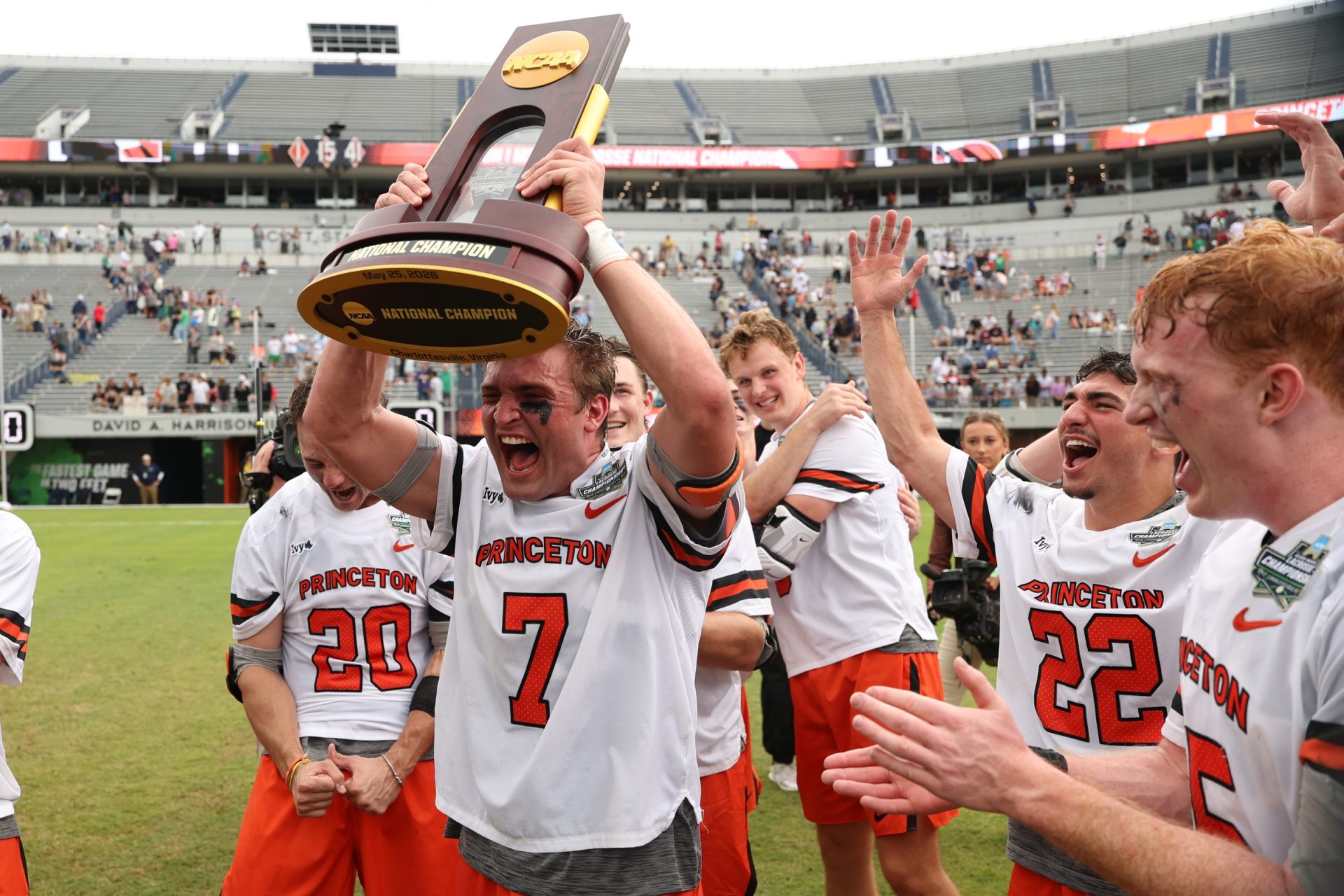 May 25, 2026; Charlottesville, VA, USA; Princeton Tigers defender Zach Friedman (7) celebrates with the national championship trophy alongside teammates after their game against the Notre Dame Fighting Irish in the NCAA Mens Lacrosse National Championship game at Scott Stadium.