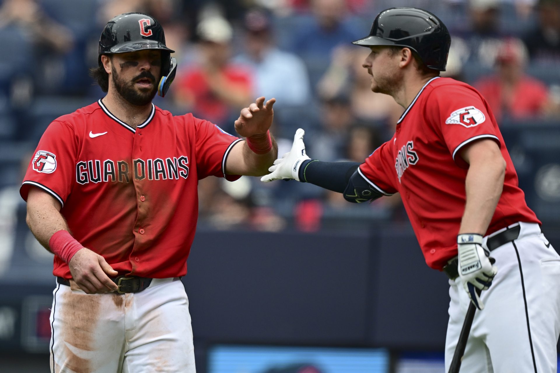 May 27, 2026; Cleveland, Ohio, USA; Cleveland Guardians catcher Austin Hedges (27) is congratulated by first baseman Kyle Manzardo (9) after scoring a run during the fifth inning against the Washington Nationals at Progressive Field.