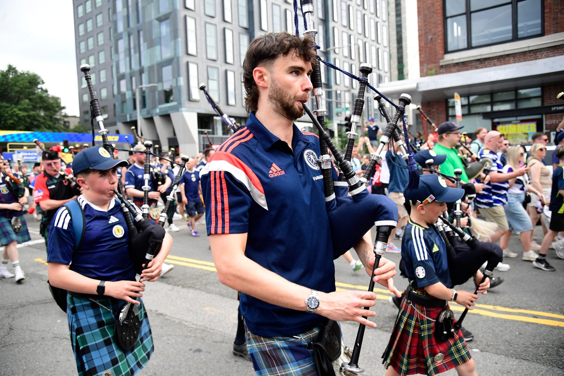 Soccer Football - FIFA World Cup 2026 - Scotland's Tartan Army march to Boston's Fenway Park baseball stadium - Boston, Massachusetts, U.S. - June 14, 2026 Scotland fans wearing kilts and playing the bagpipes during the march to Fenway Park