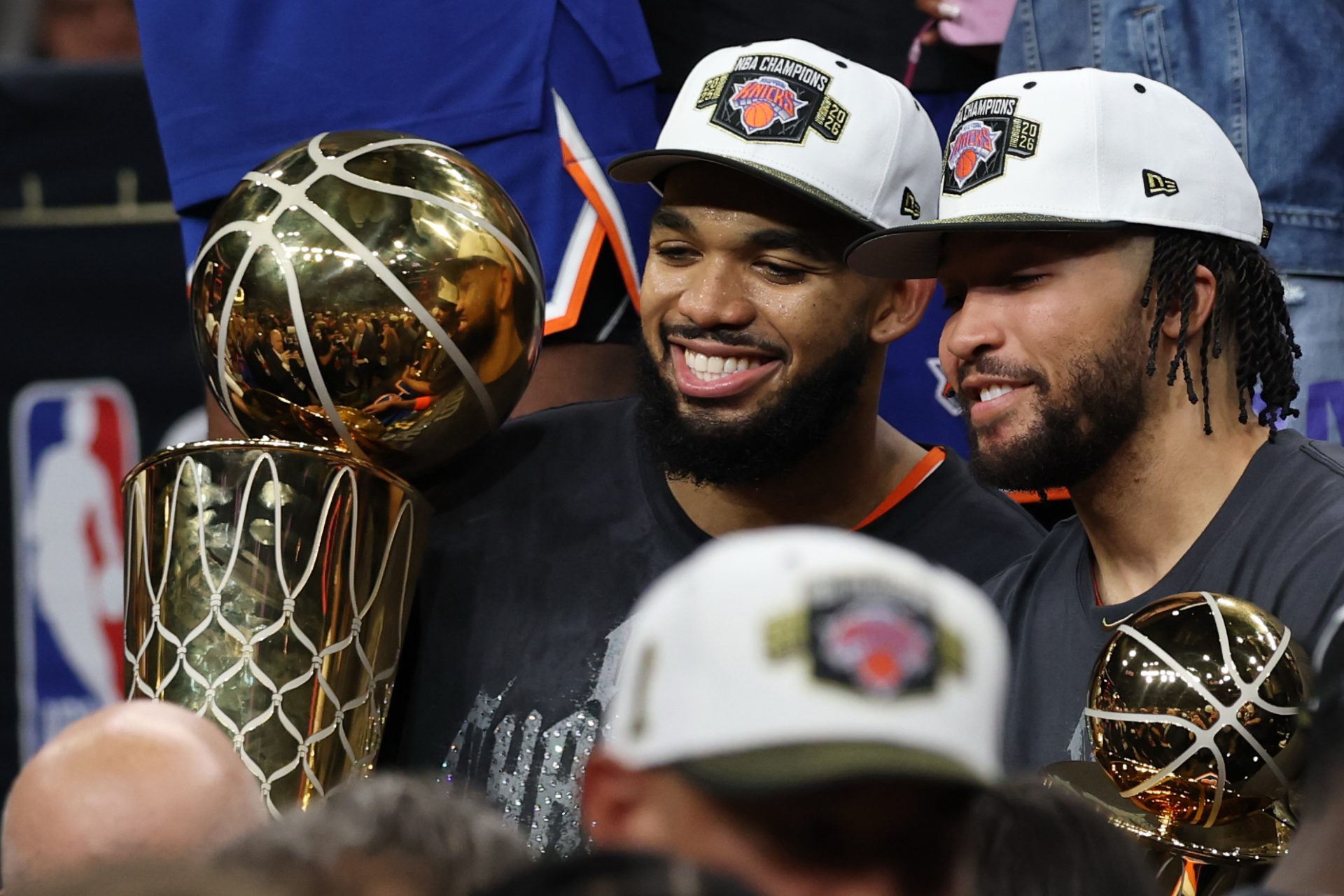 Jun 13, 2026; San Antonio, Texas, USA; New York Knicks center Karl-Anthony Towns (L) holds the Larry O'Brien championship trophy as Knicks guard Jalen Brunson (R) holds the Finals MVP trophy after game five of the 2026 NBA Finals against the San Antonio Spurs at Frost Bank Center.