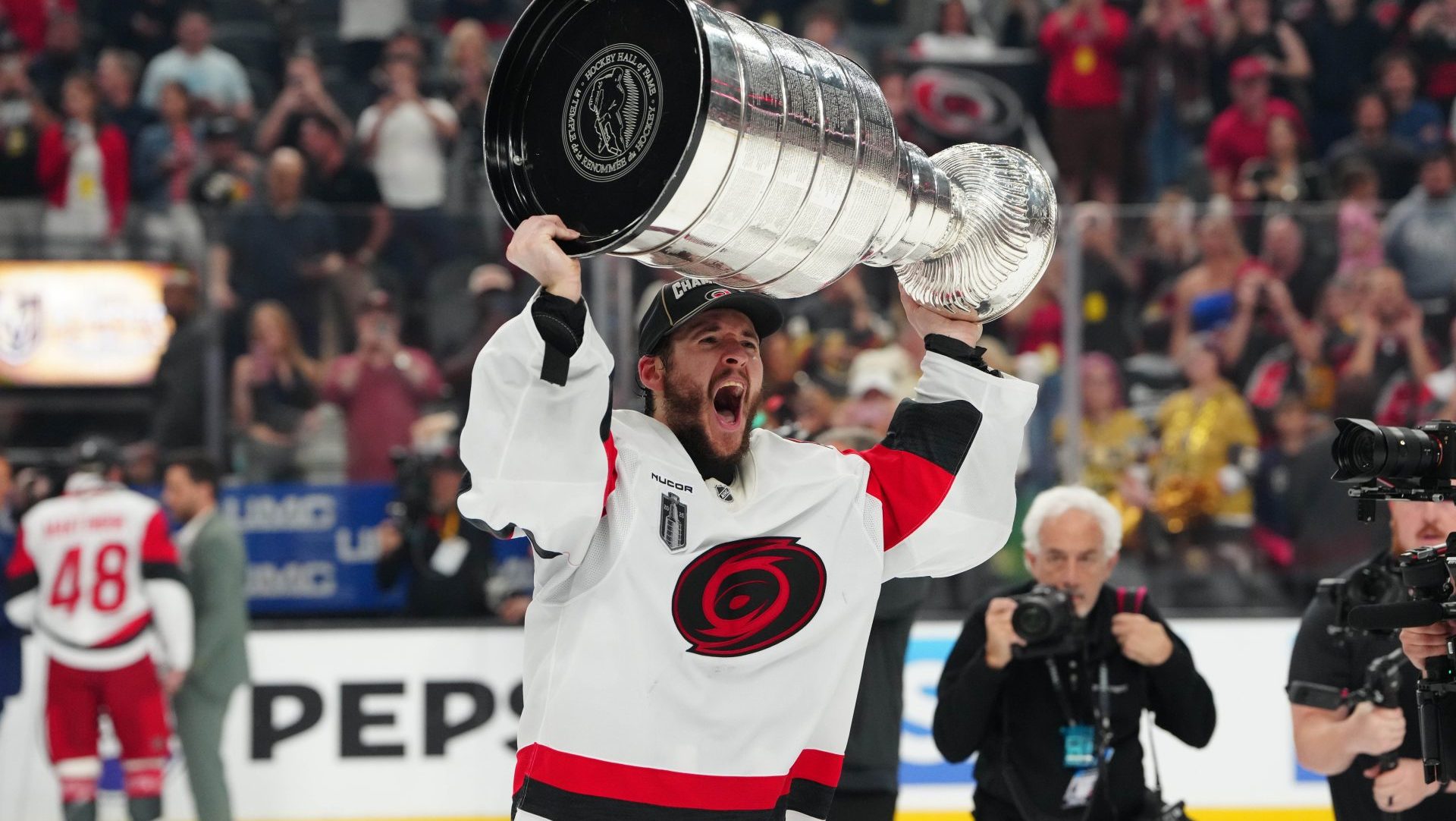 Jun 14, 2026; Las Vegas, Nevada, USA; Carolina Hurricanes goaltender Brandon Bussi (32) raises the the Stanley Cup after defeating the Vegas Golden Knights in game six of the 2026 Stanley Cup Final at T-Mobile Arena. Mandatory Credit: Stephen R. Sylvanie-Imagn Images