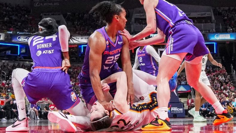 Phoenix Mercury forward Alyssa Thomas (25) scrambles to get up over Indiana Fever guard Caitlin Clark (22) on Wednesday, June 24, 2026, during a game at Gainbridge Fieldhouse in Indianapolis. The Phoenix Mercury defeated the Indiana Fever, 111-109.