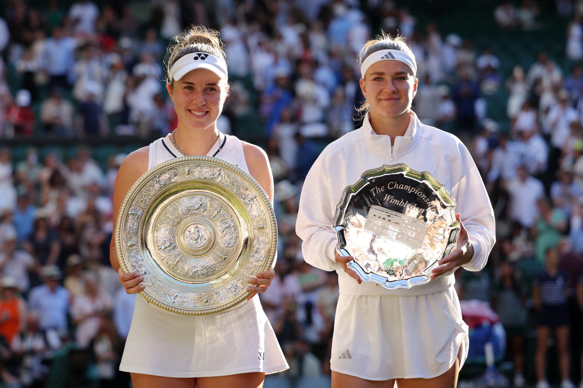 Tennis - Wimbledon - All England Lawn Tennis and Croquet Club, London, Britain - July 11, 2026 Czech Republic's Linda Noskova celebrates with the trophy as Czech Republic's Karolina Muchova celebrates with the runner-up trophy after their final match