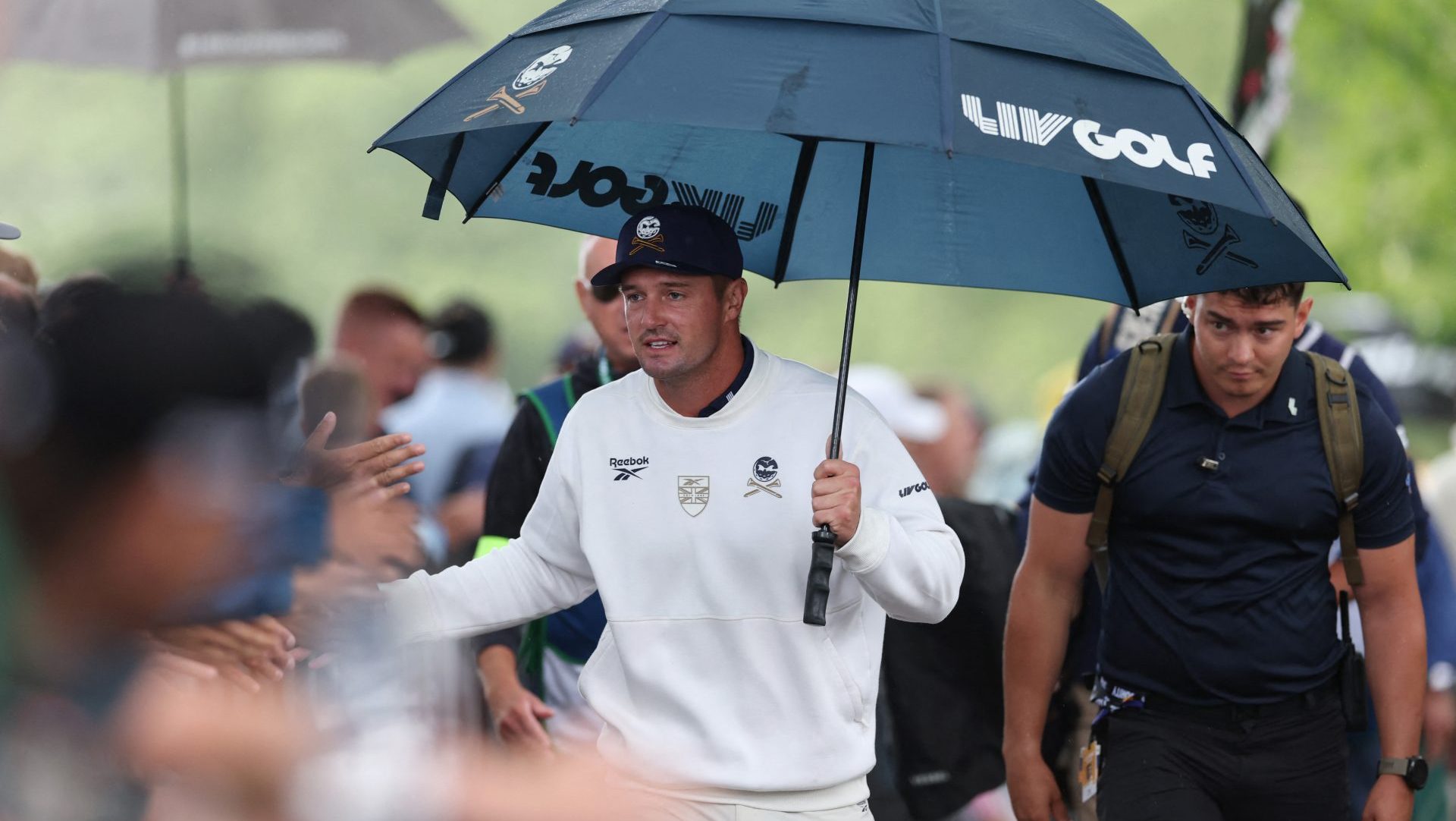 Golf - LIV Golf - United Kingdom - JCB Golf and Country Club, Uttoxeter, Britain - July 26, 2026 Crushers GC's Bryson DeChambeau holds an umbrella during the final round Action Images via Reuters/Paul Childs