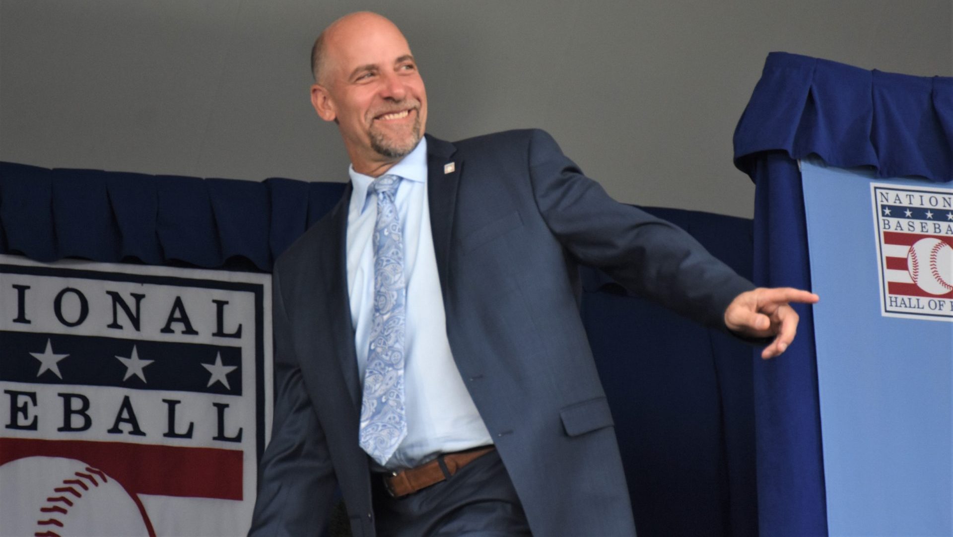 John Smoltz acknowledges the crowd during the introduction of returning inductees at the National Baseball Hall of Fame's 2024 induction ceremony Sunday, July 21, 2024, at the Clark Sports Center in Cooperstown, New York.