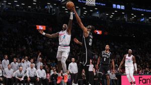Feb 7, 2025; Brooklyn, New York, USA; Brooklyn Nets center Nic Claxton (33) blocks a shot by Miami Heat guard Terry Rozier (2) during the second half at Barclays Center. Mandatory Credit: Vincent Carchietta-Imagn Images