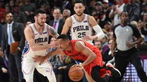 Dec 28, 2017; Portland, OR, USA; Portland Trail Blazers guard CJ McCollum (3) dribbles the ball past Philadelphia 76ers forward JJ Redick (17) and guard Ben Simmons (25) during the fourth quarter at the Moda Center. The Blazers won 114-110. Mandatory Credit: