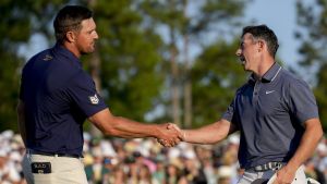 Apr 13, 2025; Augusta, Georgia, USA; Bryson DeChambeau and Rory McIlroy shake hands on no. 18 during the final round of the Masters Tournament at Augusta National Golf Club.