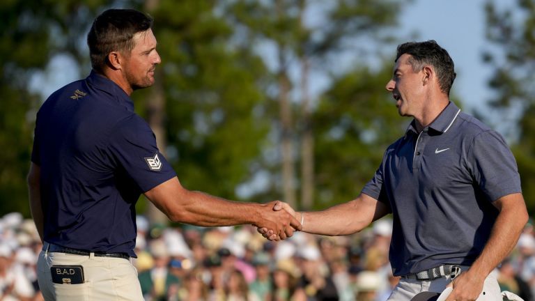 Apr 13, 2025; Augusta, Georgia, USA; Bryson DeChambeau and Rory McIlroy shake hands on no. 18 during the final round of the Masters Tournament at Augusta National Golf Club.