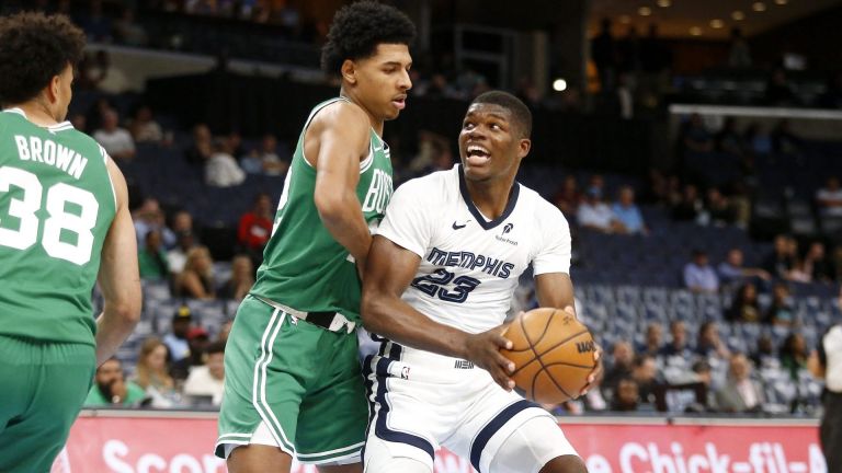 Oct 8, 2025; Memphis, Tennessee, USA; Memphis Grizzlies forward Cedric Coward (23) drives to the basket as Boston Celtics guard RJ Luis Jr. (12) defends during the fourth quarter at FedExForum