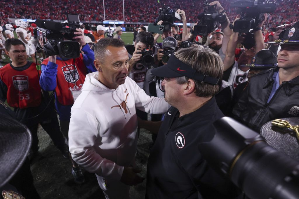 Nov 15, 2025; Athens, Georgia, USA; Texas Longhorns head coach Steve Sarkisian and Georgia Bulldogs head coach Kirby Smart interact after a game at Sanford Stadium. Mandatory Credit: Brett Davis-Imagn Images