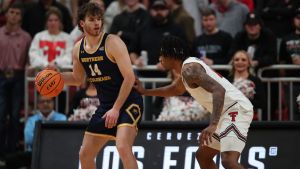 Dec 16, 2025; Lubbock, Texas, USA; Northern Colorado Bears forarwd Brock Wisne (14) dribbles the ball against Texas Tech Red Raiders forward JT Toppin (15) in the second half at United Supermarkets Arena