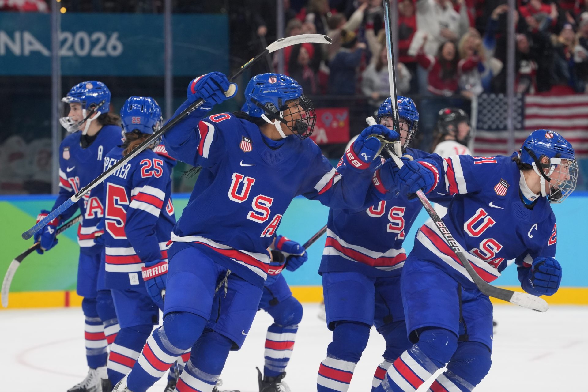 Feb 19, 2026; Milan, Italy; Hilary Knight (21) of the United States is hugged by teammates after scoring a goal against Canada in the women's ice hockey gold medal game during the Milano Cortina 2026 Olympic Winter Games at Milano Santagiulia Ice Hockey Arena.