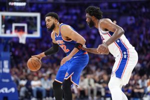 May 10, 2026; Philadelphia, Pennsylvania, USA; New York Knicks center Karl-Anthony Towns (32) controls the ball against Philadelphia 76ers center Joel Embiid (21) in the second quarter during game four of the second round of the 2026 NBA Playoffs at Xfinity Mobile Arena.
