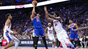May 10, 2026; Philadelphia, Pennsylvania, USA; New York Knicks guard Jalen Brunson (11) shoots the ball against Philadelphia 76ers center Joel Embiid (21) in the second quarter during game four of the second round of the 2026 NBA Playoffs at Xfinity Mobile Arena.