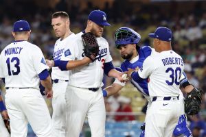 Jul 31, 2026; Los Angeles, California, USA; Los Angeles Dodgers pitcher Cole Irvin (38) hands the ball to manager Dave Roberts (30) during the ninth inning against the Boston Red Sox at Dodger Stadium.