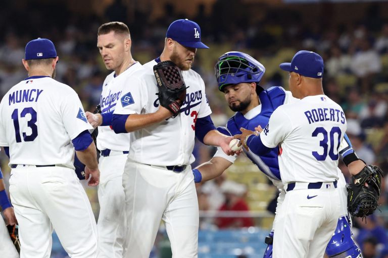 Jul 31, 2026; Los Angeles, California, USA; Los Angeles Dodgers pitcher Cole Irvin (38) hands the ball to manager Dave Roberts (30) during the ninth inning against the Boston Red Sox at Dodger Stadium.