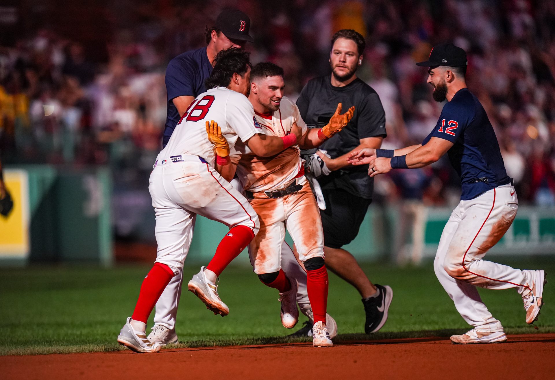 Aug 6, 2026; Boston, Massachusetts, USA; Boston Red Sox third baseman Caleb Durbin (5) is congratulated after hitting a single to center field to to drive in the winning run against the Chicago White Sox in the thirteenth inning at Fenway Park.