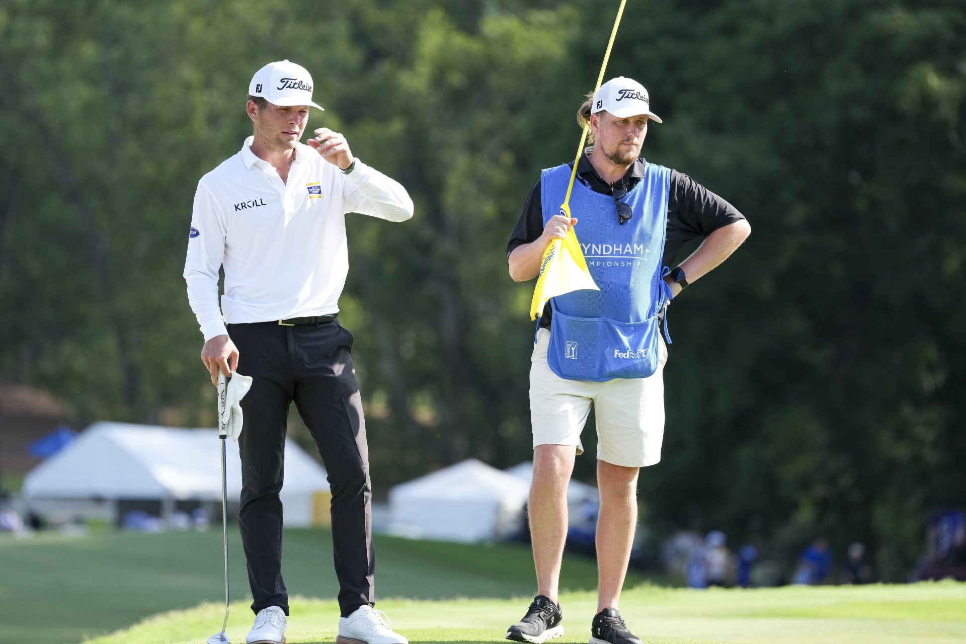 Aug 9, 2026; Greensboro, North Carolina, USA; Michael Brennan and his caddie Ollie Brett on 15 green during the final round of the Wyndham Championship golf tournament.